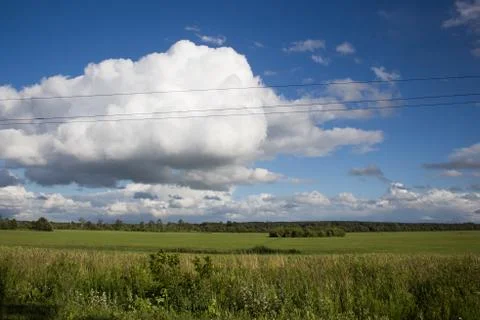 White clouds over the field Stock Photos