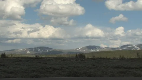 White Clouds Over Green Landscape in Yellowstone National Park Stock Footage 93834359