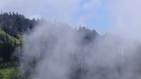 White clouds over mountain forest Stock Footage 100962486