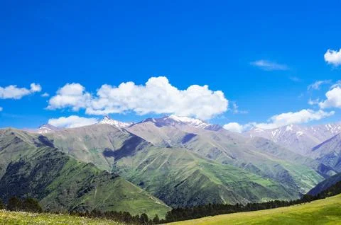 White clouds over the mountain range. Stock Photos