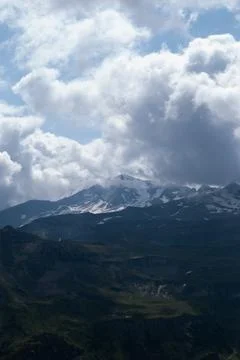 White clouds over mountains in Alps Stock Photos
