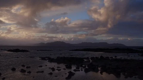 White clouds over silhouette mountains and sea at dusk Stock Footage 105418265