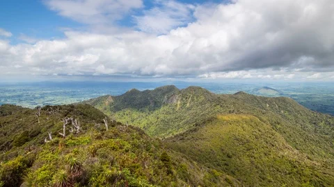 White clouds over sunny forest mountains in New Zealand wild nature Time lapse Stock Footage 105301211
