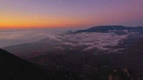 White clouds at the peak of the mountain at dawn. Timelapse 動画素材 169275854