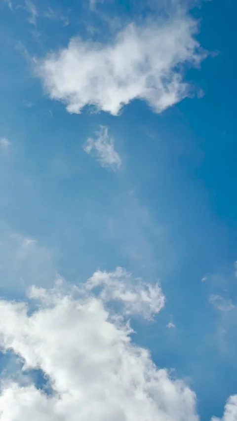 White clouds quickly floating across blue sky background with copy space text Stock Footage 334727682