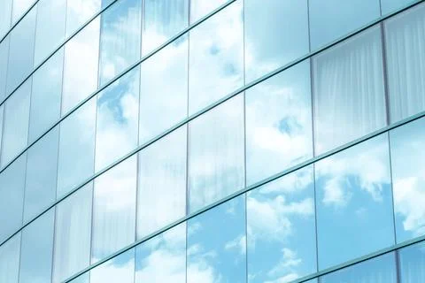 White clouds reflecting in simple modern generic office building square windo Fotos de archivo