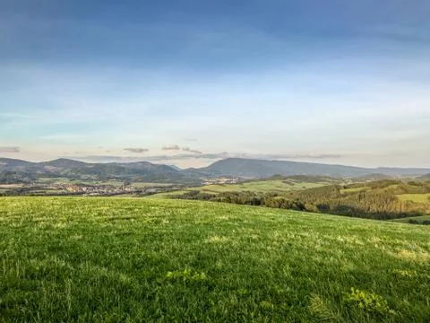 White clouds residing in the sky captured as a time-lapse over a small villag Stock-Fotos