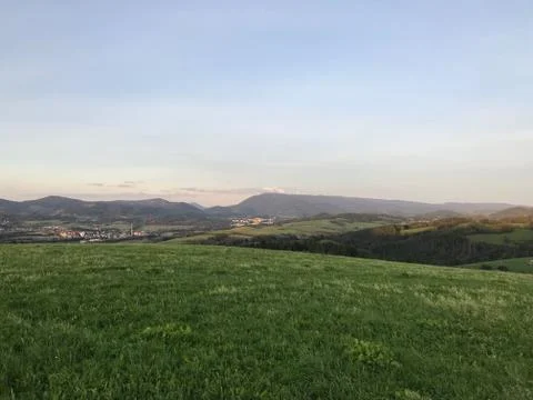 White clouds residing in the sky captured as a time-lapse over a small villag Photos