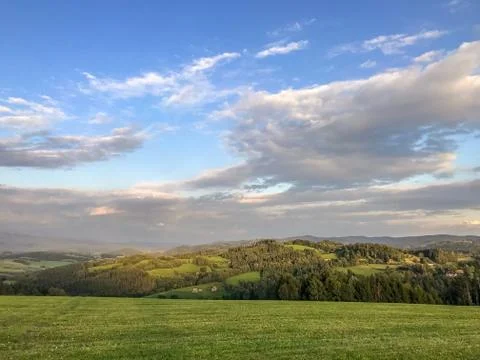 White clouds residing in the sky captured as a time-lapse over a small villag Stock-Fotos