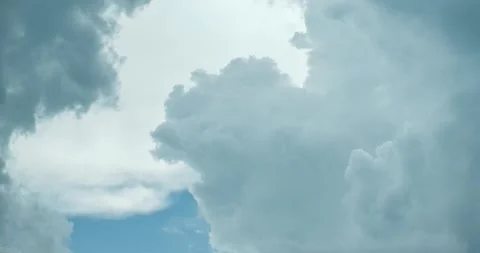 White clouds rising from the bottom up. Blue sky white clouds. Puffy fluffy. Stock Footage 254188075