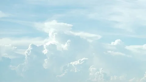 White clouds rising from the bottom up. Blue sky white clouds. Puffy Stock Footage 254188665