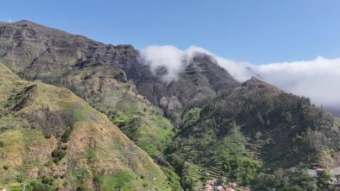 White clouds rolling off lush tropical cliffs in Madeira Stock Footage 311946947