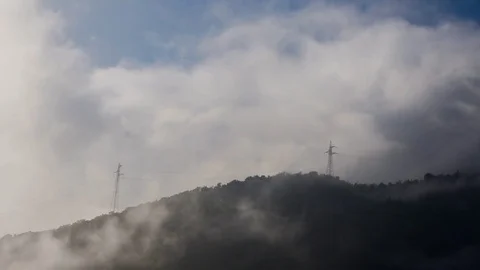 White clouds rolling over the mountains Stock Footage 76004827