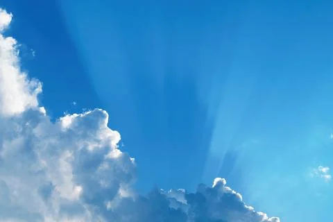 White clouds with shadows cast by the sun through the haze on blue sky Stock Photos