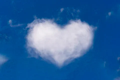 White clouds in the shape of heart on a blue sky Stock Photos