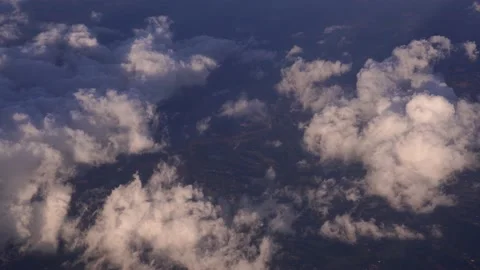 White clouds in the sky above the ground. View from the side of the plane Stock Footage 164817535