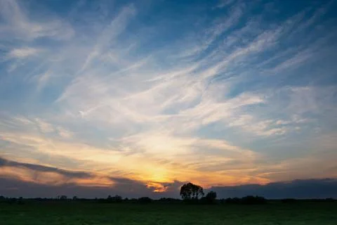 White clouds on sky after sunset, photo with low horizon Stock Photos