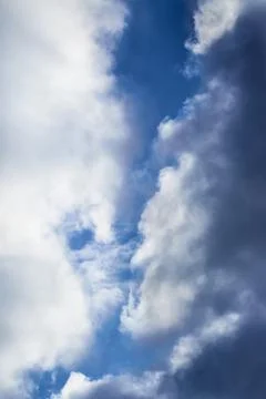 White clouds in the sky and between them you can see the blue sky Stock Photos
