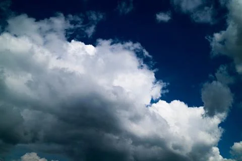 White clouds on the sky at midday before the storm. Stock Photos