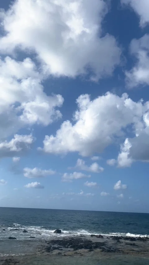 White clouds in the sky over the sea. Vertical video  Stock Footage 286737690