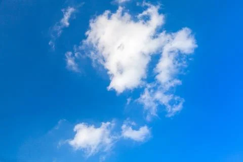 White clouds, small formation in blue sky Stock Photos
