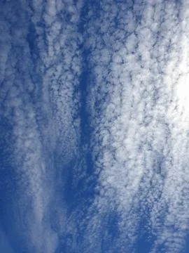 White clouds texture pattern in vertical blue sky Stock Photos