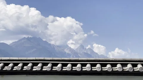White Clouds Time-lapse over Mountains with Chinese Roof - 4K Stock Footage 340131599