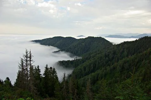 White clouds at the top of the mountains. Stock Photos