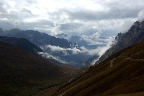 White clouds at the top of the mountains. Stock Photos