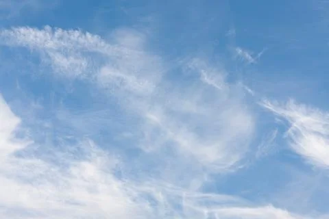 White clouds under the blue sky. Atmosphere, weather. Look in the sky. Stock Photos