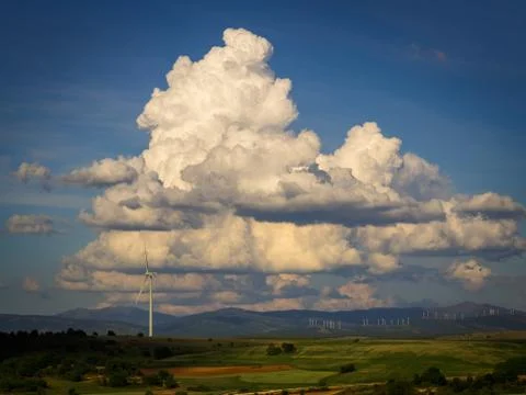 White clouds, windmill and field Stock Photos