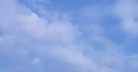 White clouds within a blue sky on a sunny day.  Video stock 83873062