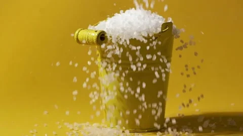 White coarse salt crystals falling in the yellow bucket Stock Footage 233903149