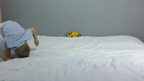 On a white coating, the kid does somersaults Stock Footage 139181453