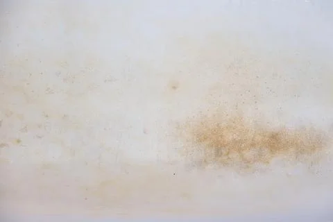 White coating, which is covered with rust. Stock Photos