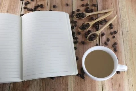 White coffee cup and empty book. Stock Photos