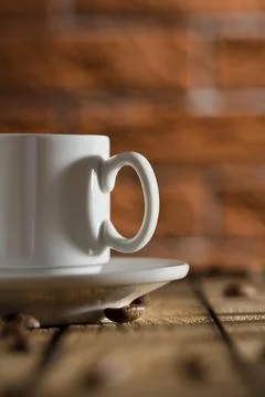 White coffee cup on a background of a brick wall Foto stock