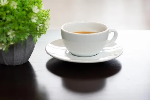 White coffee cup on a brown table in  cafe Stock Photos