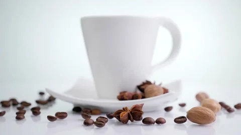 White coffee cup with coffee beans rotating on a white background. Stock Footage 130254634
