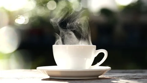 White coffee cup, mug with steaming smoke of coffee on old wooden table Stock Footage 227172927