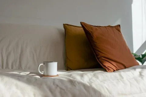 White coffee cup on the sofa in concept of resting and relaxation Stock-Fotos