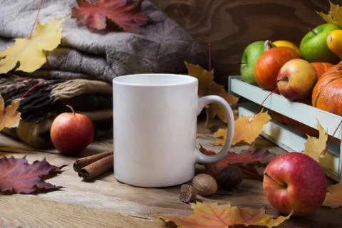 White coffee mug mockup with fall leaves and knitted plaid Stock Photos