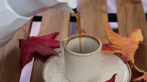 White coffee pot pouring coffee into cup in slow motion Stock-Footage 294186415