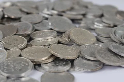 White coins of different denomination in random order. Stock Photos