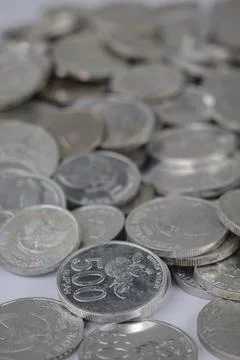 White coins of different denomination in random order. Stock Photos