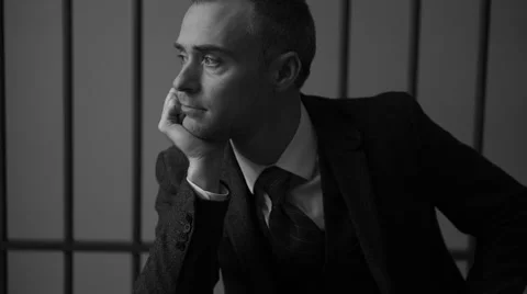 A white collar criminal seated in prison… | Stock Video | Pond5