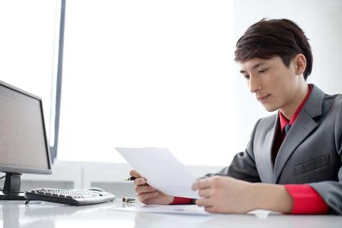 A white-collar worker is busy working in the office Stock Photos