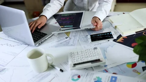 White collar workers who use mobile phones and computers to analyze stock da Stock Footage 193993958