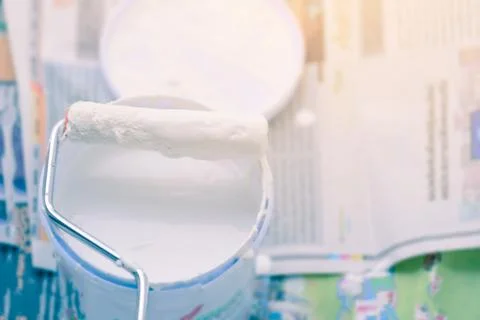 White color in bucket for paint wall with paint roller. Stock Photos