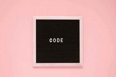 White color letter in word code on black felt board background. Stock Photos